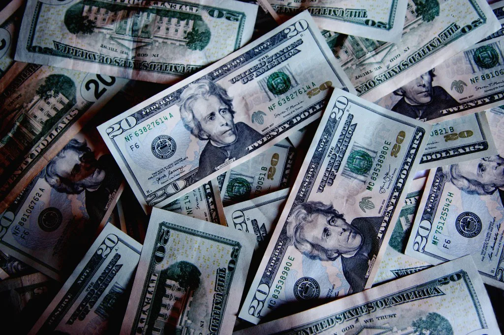 A pile of overlapping US twenty-dollar bills
